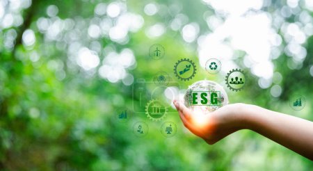 Foto de ESG icon concept in hand for environmental, social and governance in sustainable and ethical business on Network connection on green background. Ideas for production and conservation of environment. - Imagen libre de derechos