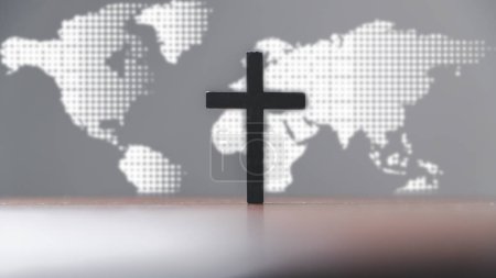 Jesus christ cross on wooden table with world map blur background. Idea of mission evangelism and gospel on world. Copy space for text, Christian background for great commission or earth day concept.