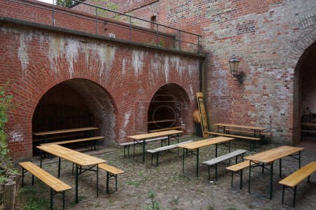 Photo for Seating area with tables and benches in the fortress. The Spandau Citadel, German: Zitadelle Spandau, is a fortress in Berlin, Germany. - Royalty Free Image