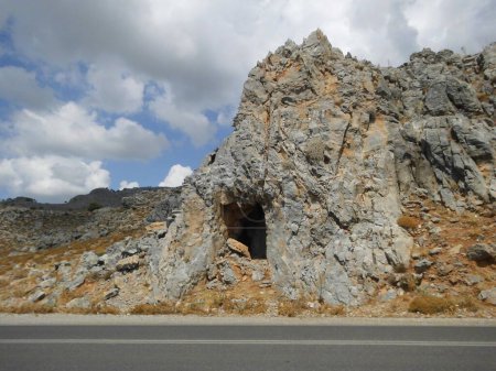The cave in the mountain is located near the Eparchiaki Odos Pilonas-Katavias highway. Gennadi, Rhodes Island, Greece