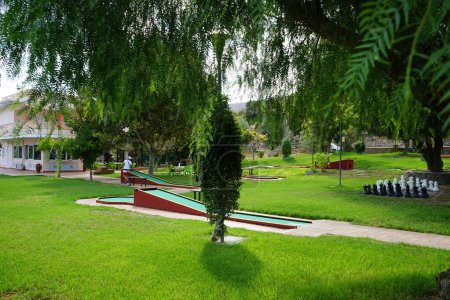 Photo for Miniature golf in Lardos. Miniature golf, minigolf, putt-putt, crazy golf, and by several other names is an offshoot of the sport of golf focusing solely on the putting aspect of its parent game. Lardos, Rhodes Island, South Aegean region, Greece - Royalty Free Image