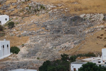 The ancient Greek theatre of Lindos is considered to be the most important monumental building in the lower town of Lindos.  The construction of the theatre goes back to the 4th c. BC. Rhodes Island, Dodecanese, Greece
