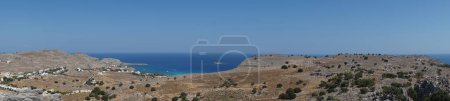 Photo panorama. View from the territory of the medieval Church of Prophet Elias to the surrounding area of Pefki. Pefkos or Pefki is a well-known beach resort located on the eastern coast of Rhodes Island, Greece