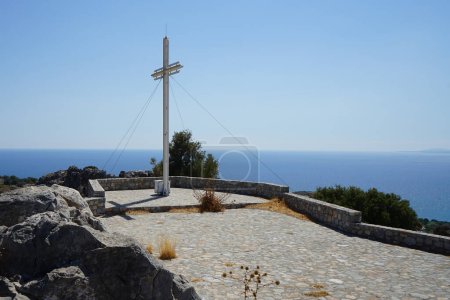 A large cross stands on a hill near the Church of Prophet Elias. It's thought that Prophet Elias Church which overlooks Pefkos dates from the 12th Century AD. Pefkos or Pefki, Rhodes island, Greece 