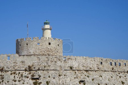 View of the Fortress of Agios Nikolaos in August. The Fortress of Agios Nikolaos or Fort of Saint Nicholas is a single stronghold that occupies the northern tip of the homonymous pier. Rhodes city, Rhodes island, Greece