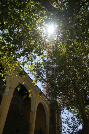 The sun shines through the branches of a tree over Ibrahim Pasha Mosque in the medieval town of Rhodes. Ibrahim Pasha Mosque is an Ottoman-era mosque on the Aegean island of Rhodes, Greece.