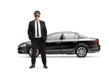 Photo for Full length portrait of a mature chauffeur posing in front of a black car isolated on white background - Royalty Free Image