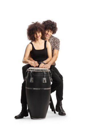 Téléchargez les photos : Jeune couple jouant de la batterie conga ensemble isolé sur fond blanc - en image libre de droit