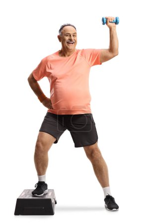 Photo for Full length portrait of a mature man exercising step aerobic with a small weight isolated on white background - Royalty Free Image