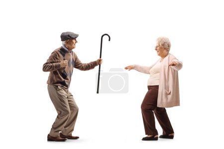Full length profile shot of an elderly husband and wife dancing isolated on white background