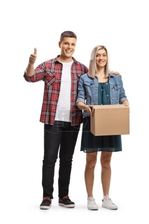 Photo for Young man and woman standing with a cardboard box and showing thumbs up isolated on white background - Royalty Free Image