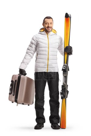 Photo for Young man with a suitcase and pair of skiis isolated on white background - Royalty Free Image