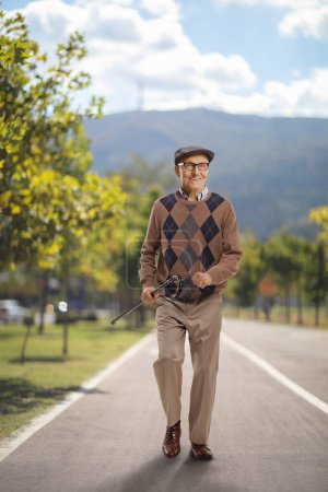 Happy elderly man walking on a pedestrian track