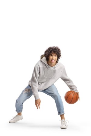 Photo for Young man in jeans playing basketball isolated on white background - Royalty Free Image