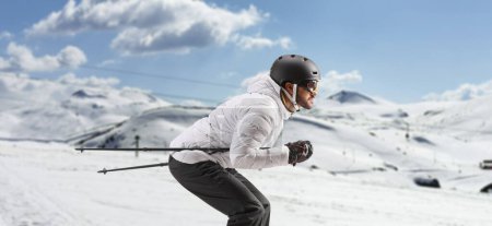 Photo for Profile shot of a male skier skiing on a mountai - Royalty Free Image