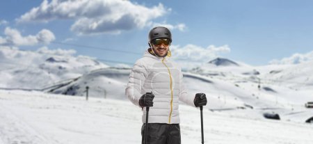 Photo for Man with skis posing on a ski resor - Royalty Free Image