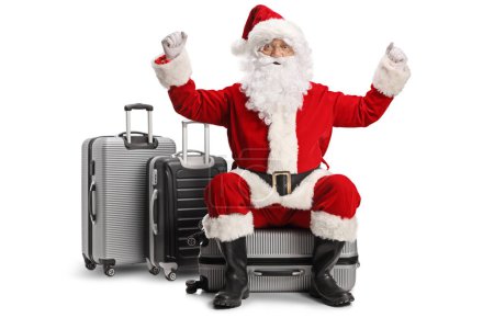 Photo for Happy santa claus sitting on a suitcase isolated on white background - Royalty Free Image