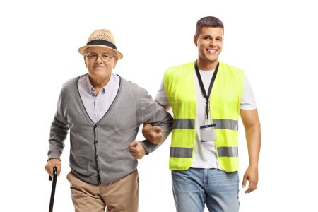 Photo for Young male community worker helping an elderly man with a cane isolated on white background - Royalty Free Image