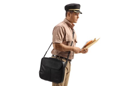 Photo for Profile shot of a mailman with a bag delivering letters isolated on white background - Royalty Free Image