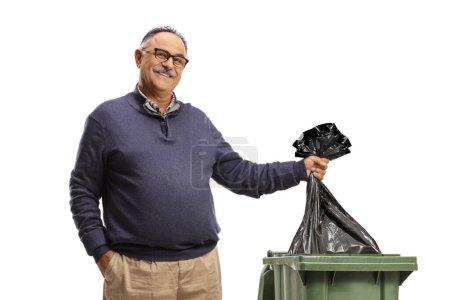 Photo for Mature man throwing a plastic bag in a bin isolated on white background - Royalty Free Image