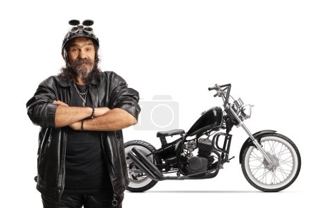Photo for Mature bearded biker with a helmet and leather jacket in front of a chopper isolated on white background - Royalty Free Image