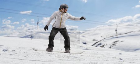 Photo for Full length shot of a man riding a snowboard on a snowy hill - Royalty Free Image