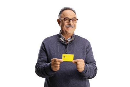 Foto de Happy mature man holding a credit card isolated on white background - Imagen libre de derechos