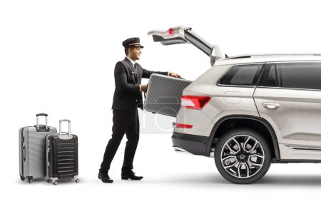Téléchargez les photos : Bellboy putting suitcase in the trunk of a SUV isolated on white background - en image libre de droit