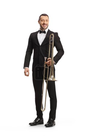 Photo for Full length portrait of a male musician posing with a trombone isolated on white background - Royalty Free Image