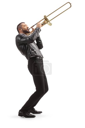 Photo for Full length side shot of a male musician playing a trombone isolated on white background - Royalty Free Image