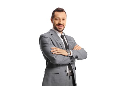 Téléchargez les photos : Portrait of a man in a grey suit smiling and posing with crossed arms isolated on white background - en image libre de droit