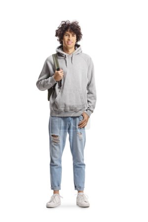 Photo for Full length portrait of a guy with curly hair carrying a backpack and posing isolated on white background - Royalty Free Image