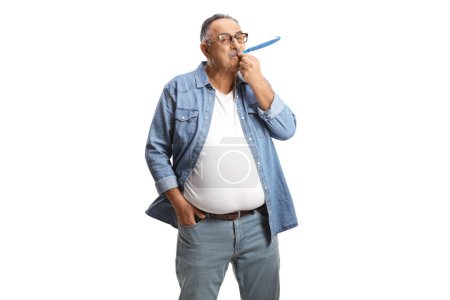 Foto de Casual mature man blowing a party horn isolated on white background - Imagen libre de derechos