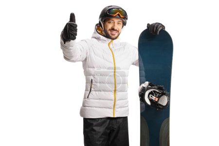 Photo for Young man leaning a snowboard and gesturing thumbs up isolated on white background - Royalty Free Image