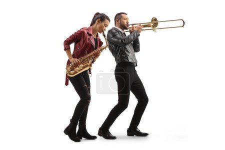 Foto de Full length shot of a young woman playing a sax and man playing a trombone isolated on white background - Imagen libre de derechos