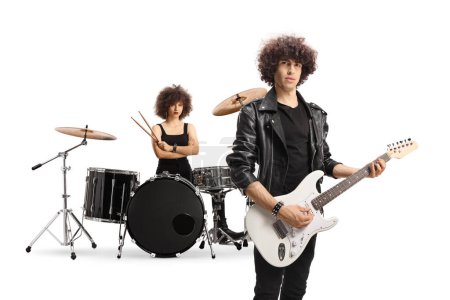 Téléchargez les photos : Male musician with an electric guitar and a female drummer in the back isolated on white background - en image libre de droit