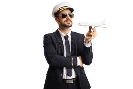 Photo for Pilot holding a small airplane model isolated on white background - Royalty Free Image