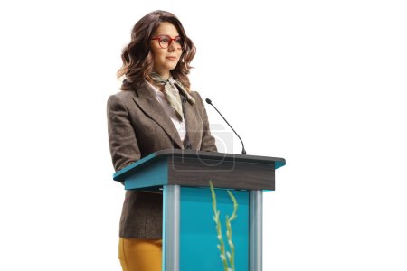 Téléchargez les photos : Young woman speaker on a pedestal giving a speech isolated on white background - en image libre de droit