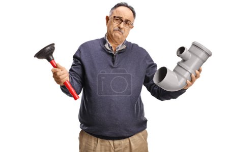 Photo for Disappointed mature man holding a pipe and a plunger isolated on white background - Royalty Free Image