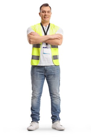 Photo for Full length portrait of a security guard in a safety vest standing with crossed arms isolated on white background - Royalty Free Image