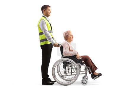 Téléchargez les photos : Full length profile shot of a security guard with a woman in a wheelchair isolated on white background - en image libre de droit