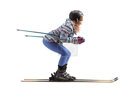 Téléchargez les photos : Full length profile shot of a woman skiing isolated on a white background - en image libre de droit