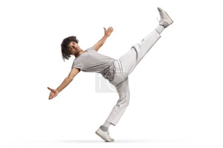 Téléchargez les photos : African american young male dancer with leg up isolated on white background - en image libre de droit