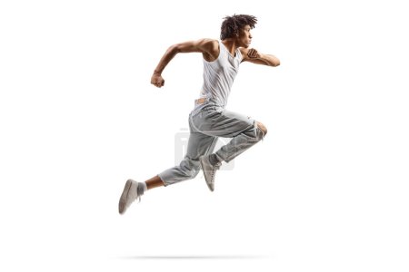 Foto de Full length profile shot of an african american male dancer jumping isolated on white background - Imagen libre de derechos