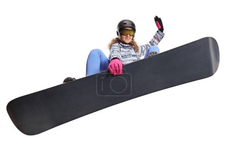 Téléchargez les photos : Femme sautant avec un snowboard isolé sur fond blanc - en image libre de droit
