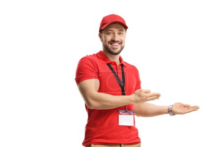 Photo for Smiling male shop assistant gesturing welcome isolated on white background - Royalty Free Image