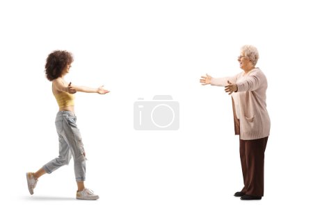 Téléchargez les photos : Full length profile shot of a young woman meeting her grandmother isolated on white background - en image libre de droit