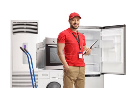 Foto de Sales manager posing with domestic electrical appliances isolated on white background - Imagen libre de derechos