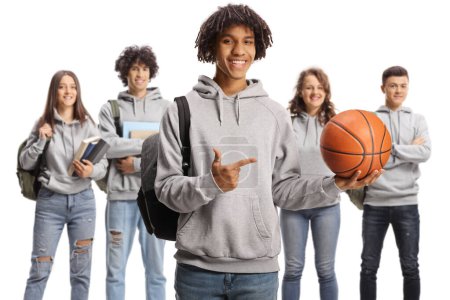 Téléchargez les photos : African american male student holding a basketball and pointing and group of students standing in the back isolated on white background - en image libre de droit