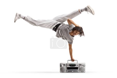 Photo for Afro american male dancer performing a handstand with a boombox isolated on white background - Royalty Free Image